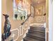 Stairway with wooden steps, decorative wall paneling, and a sunlit window with elegant decor at 3149 Scrub Oak Trl, Oviedo, FL 32765