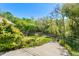 Landscaped backyard with a walkway and fencing at 3149 Scrub Oak Trl, Oviedo, FL 32765