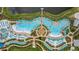 Stunning aerial view of a community pool area, complete with sun loungers and lush landscaping at 3192 Caribbean Soul Dr, Kissimmee, FL 34747