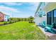 Green backyard with two blue Adirondack chairs at 3192 Caribbean Soul Dr, Kissimmee, FL 34747