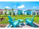 Backyard with outdoor seating that offers views of the colorful townhome exteriors at 3192 Caribbean Soul Dr, Kissimmee, FL 34747