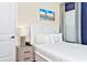 Comfortable bedroom showcasing a luxury bed, decorative lamp, a light gray nightstand, and serene wall art at 3192 Caribbean Soul Dr, Kissimmee, FL 34747