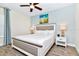 Relaxing bedroom boasting a king bed, modern ceiling fan, and beach-themed wall decor for a coastal vibe at 3192 Caribbean Soul Dr, Kissimmee, FL 34747