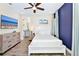 Comfortable bedroom features a ceiling fan, wood-look tile flooring, and ensuite bathroom at 3192 Caribbean Soul Dr, Kissimmee, FL 34747