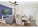 Open-concept dining area and living room featuring modern decor and abundant natural light at 3192 Caribbean Soul Dr, Kissimmee, FL 34747