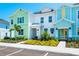 Colorful townhomes showcase vibrant facades and landscaping, creating a welcoming streetscape at 3192 Caribbean Soul Dr, Kissimmee, FL 34747
