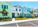 Townhomes with colorful exteriors are enhanced by lush landscaping and inviting entryway benches at 3192 Caribbean Soul Dr, Kissimmee, FL 34747