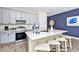 Bright kitchen with stainless steel appliances, quartz countertops, white cabinets, and wood tile flooring at 3192 Caribbean Soul Dr, Kissimmee, FL 34747