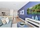 Spacious living area flows into a modern kitchen, with an accent wall and decor at 3192 Caribbean Soul Dr, Kissimmee, FL 34747
