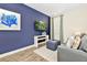Comfortable living room area with a blue accent wall, modern decor, and plenty of natural light at 3192 Caribbean Soul Dr, Kissimmee, FL 34747