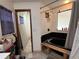 Bathroom with an installed dark-tiled shower and dark bathtub, ready for renovation at 324 Bonita Rd, Debary, FL 32713