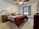 This bedroom features neutral walls, carpet, a fan, and natural light from the single window at 324 Bonita Rd, Debary, FL 32713