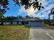 Charming single-story brick home featuring a two-car garage and well-maintained lawn at 324 Bonita Rd, Debary, FL 32713