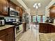 Open kitchen with wooden cabinets, granite countertops, and stainless steel appliances at 324 Bonita Rd, Debary, FL 32713