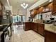 Open kitchen with wooden cabinets, granite countertops, and stainless steel appliances at 324 Bonita Rd, Debary, FL 32713