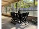 The screened-in porch offers a cozy outdoor space for dining and leisure with a view of the backyard at 324 Bonita Rd, Debary, FL 32713