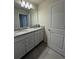 Modern bathroom features a granite countertop with double sinks and tile flooring at 3990 Lana Ave, Davenport, FL 33897