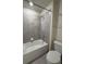 Bathroom featuring neutral gray tiling, a bathtub, and matching gray fixtures at 3990 Lana Ave, Davenport, FL 33897