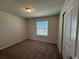 Carpeted bedroom with a window and large closet for storage at 3990 Lana Ave, Davenport, FL 33897