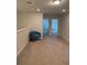 Spacious hallway with neutral carpet and paint featuring a chair in the corner at 3990 Lana Ave, Davenport, FL 33897