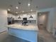 Open kitchen with a granite island, stainless steel appliances, and white cabinetry at 3990 Lana Ave, Davenport, FL 33897