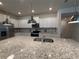 Spacious kitchen featuring granite countertops, pendant lighting, and modern stainless steel appliances at 3990 Lana Ave, Davenport, FL 33897