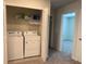 Functional laundry closet equipped with shelving and a side by side washer and dryer at 3990 Lana Ave, Davenport, FL 33897