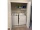 Functional laundry closet equipped with shelving and a side by side washer and dryer at 3990 Lana Ave, Davenport, FL 33897