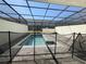 Private screened-in pool area with a safety fence and ample space for outdoor relaxation at 3990 Lana Ave, Davenport, FL 33897