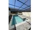 Relax in this screened in pool with a water view and patio area at 3990 Lana Ave, Davenport, FL 33897