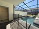 Inviting screened-in pool area with an attached half-bathroom, providing a private outdoor oasis at 3990 Lana Ave, Davenport, FL 33897