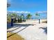 Sandy volleyball court with a net and palm trees, ideal for beach volleyball matches at 3990 Lana Ave, Davenport, FL 33897