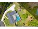 Drone's-eye view of the property including pool and deck, spacious backyard and lengthy driveway at 400 Royal Palm Ct, Longwood, FL 32779