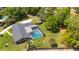 Aerial view showcasing the backyard pool, mature trees, and well maintained exterior at 400 Royal Palm Ct, Longwood, FL 32779