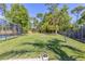 Well-maintained backyard with a lush lawn, fire pit, and screened-in pool area for outdoor enjoyment at 400 Royal Palm Ct, Longwood, FL 32779