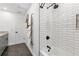 Bathroom boasts subway tile shower with black fixtures, marble floors, and a modern towel rack at 400 Royal Palm Ct, Longwood, FL 32779