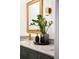 Bathroom vanity features marble countertops, gold faucet, dark cabinets, and gold framed mirror at 400 Royal Palm Ct, Longwood, FL 32779