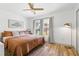 Inviting bedroom with a cozy bed, warm lighting, and a view of the outdoors at 400 Royal Palm Ct, Longwood, FL 32779
