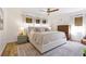 Cozy bedroom with a plush bed, textured rug, and abundant natural light through large windows at 400 Royal Palm Ct, Longwood, FL 32779