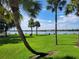 Community greenspace and lake view featuring mature palm trees and a lake at 400 Royal Palm Ct, Longwood, FL 32779
