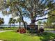Sweetwater Beach community entrance sign featuring lush landscaping and a view of the lake at 400 Royal Palm Ct, Longwood, FL 32779