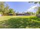 A home's exterior with a garage, storage shed, lengthy driveway, and ample green lawn at 400 Royal Palm Ct, Longwood, FL 32779