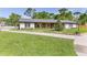 Well maintained ranch home featuring lush landscaping, a circle drive, and updated exterior at 400 Royal Palm Ct, Longwood, FL 32779