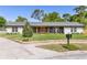 Charming single-story home with beautifully landscaped front yard, updated paint, and inviting entrance at 400 Royal Palm Ct, Longwood, FL 32779