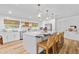 Bright kitchen with a large island, seating, and modern lighting fixtures at 400 Royal Palm Ct, Longwood, FL 32779