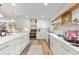 Bright kitchen featuring white cabinets, marble countertops, and modern appliances at 400 Royal Palm Ct, Longwood, FL 32779