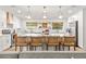 Bright kitchen with a large island, seating, and modern lighting fixtures at 400 Royal Palm Ct, Longwood, FL 32779