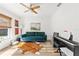 Inviting living room featuring a stylish couch, modern artwork, and a sleek piano at 400 Royal Palm Ct, Longwood, FL 32779