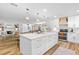 Open concept layout showcasing the kitchen, dining, and living areas with wood floors at 400 Royal Palm Ct, Longwood, FL 32779