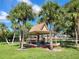 Charming picnic area with covered pavilion, tables, and surrounding palm trees at 400 Royal Palm Ct, Longwood, FL 32779